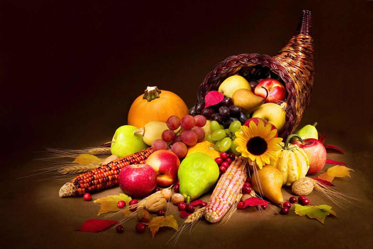 A cornucopia filled with fruits and vegetables on a table