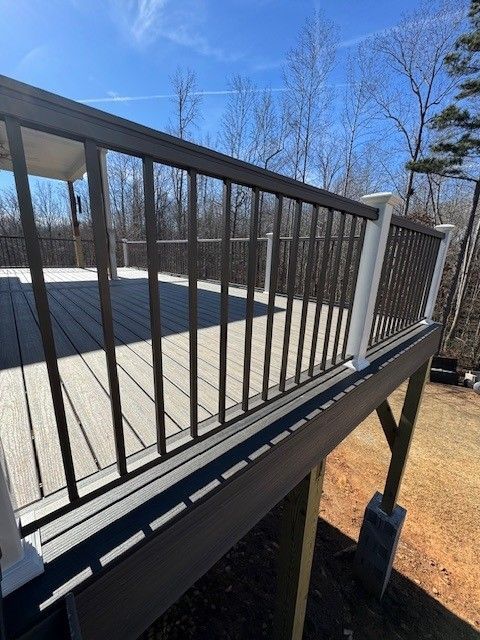 Composite deck with dark railings and spindles, white posts.