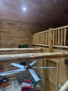 A log cabin with a ceiling fan