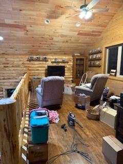 A living room filled with furniture and a ceiling fan