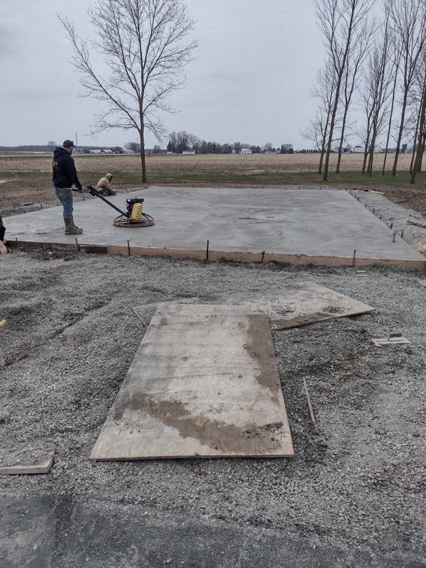 A man is working on a concrete slab