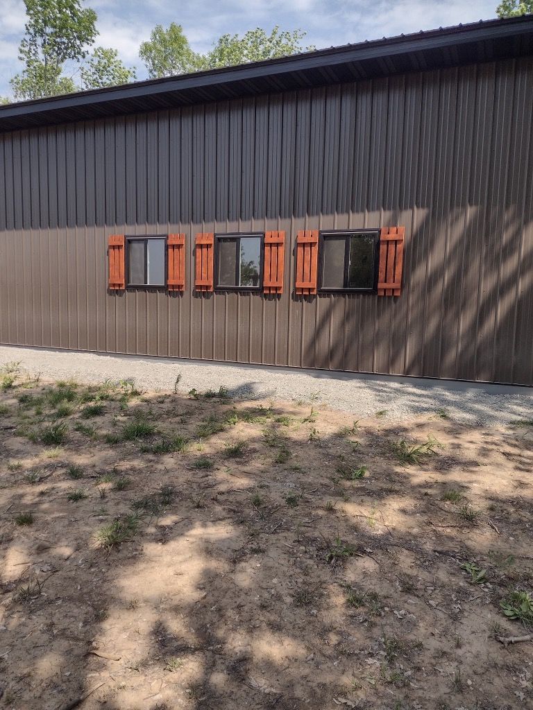 A shed with a lot of windows on the side of it
