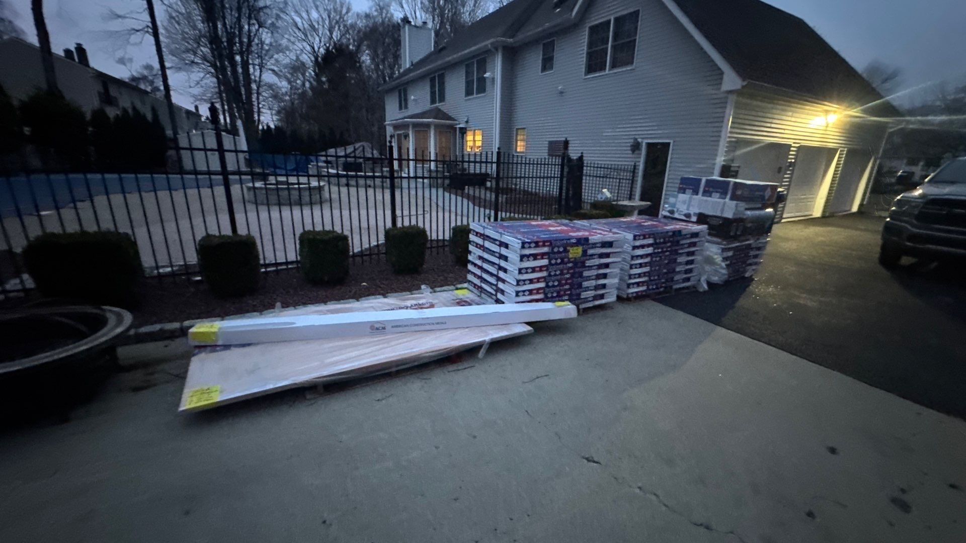 A bunch of boxes are sitting on the ground in front of a house.