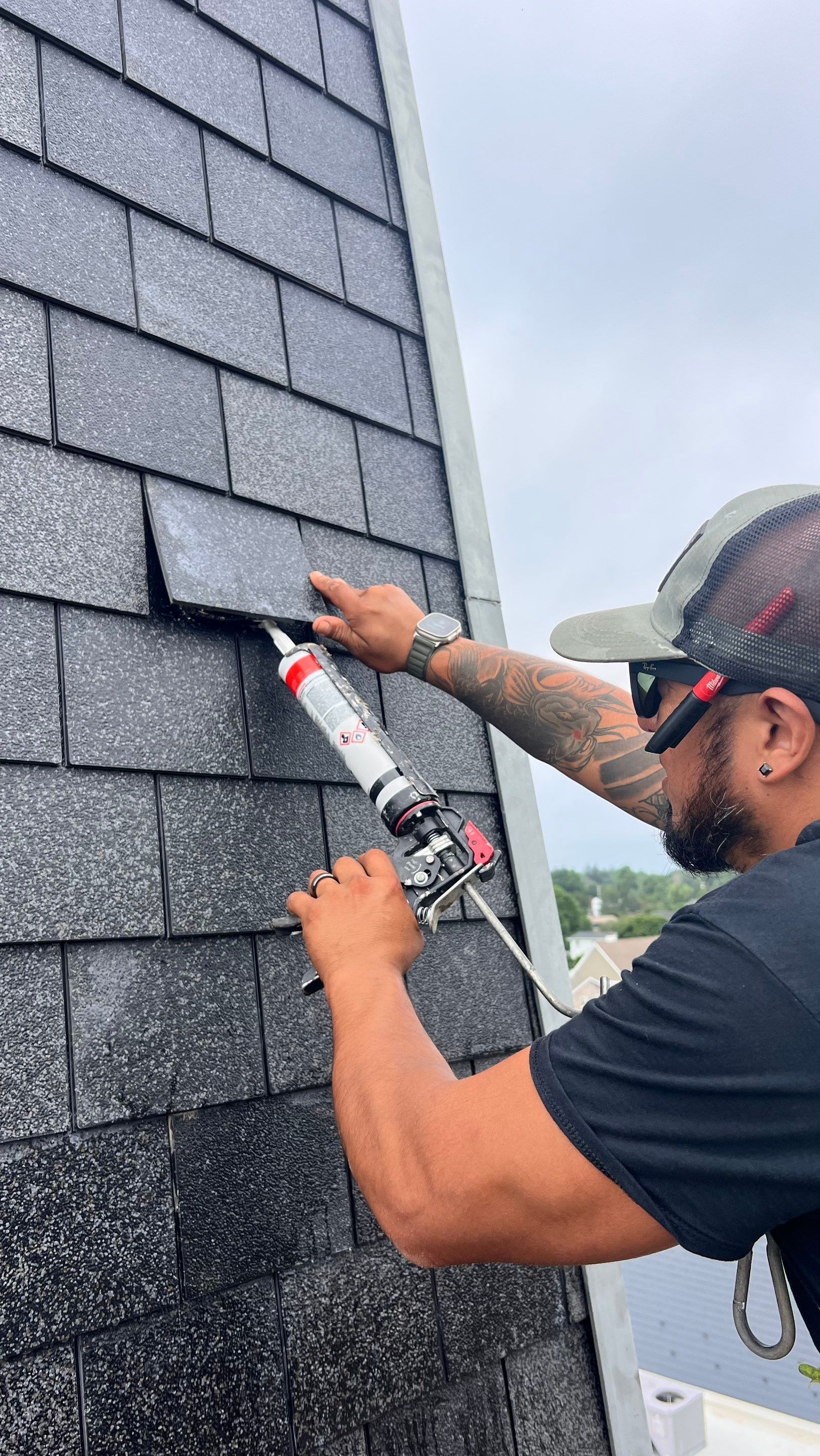 A man is installing shingles on a roof.