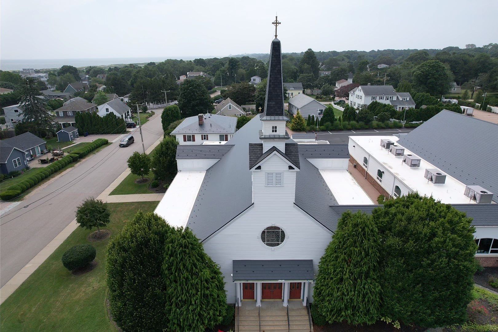 An aerial view of a church in a small town.