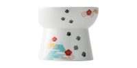 White ceramic container with floral patterns and a turquoise design on the front
