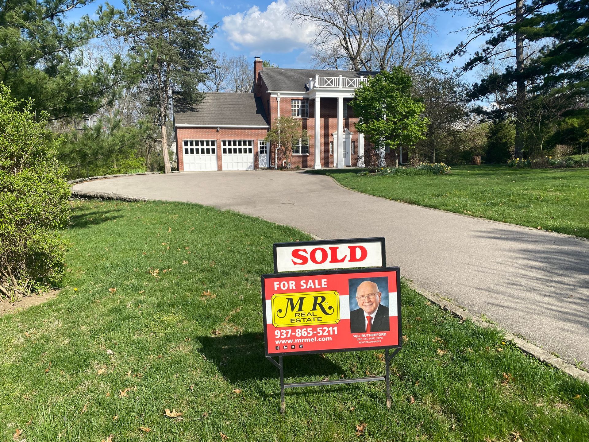 A house with a sold sign in front of it