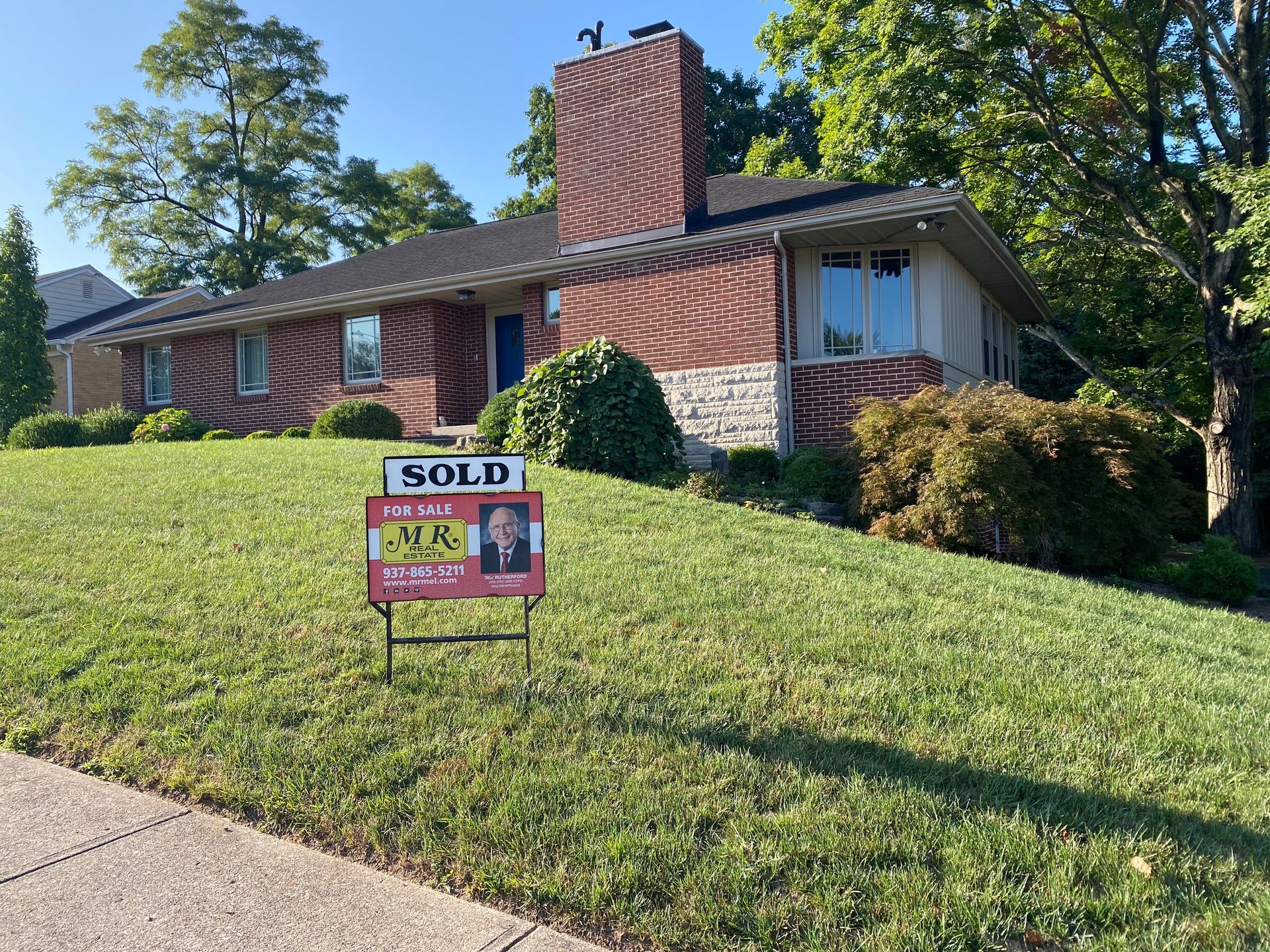 A house with a sold sign in front of it