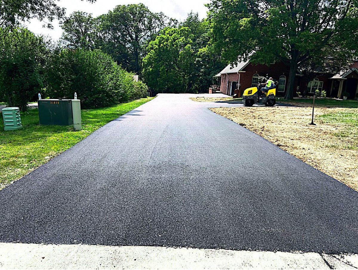 A newly paved road is being built next to a house