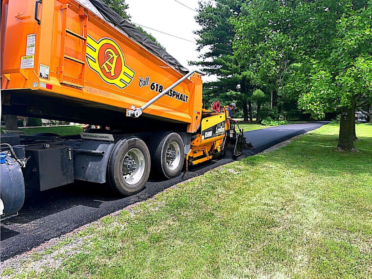 A dump truck is sitting on the side of a road