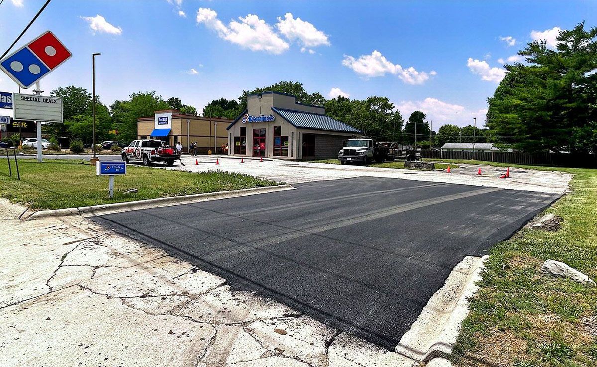 A newly paved driveway going to Domino's Pizza Restaurant