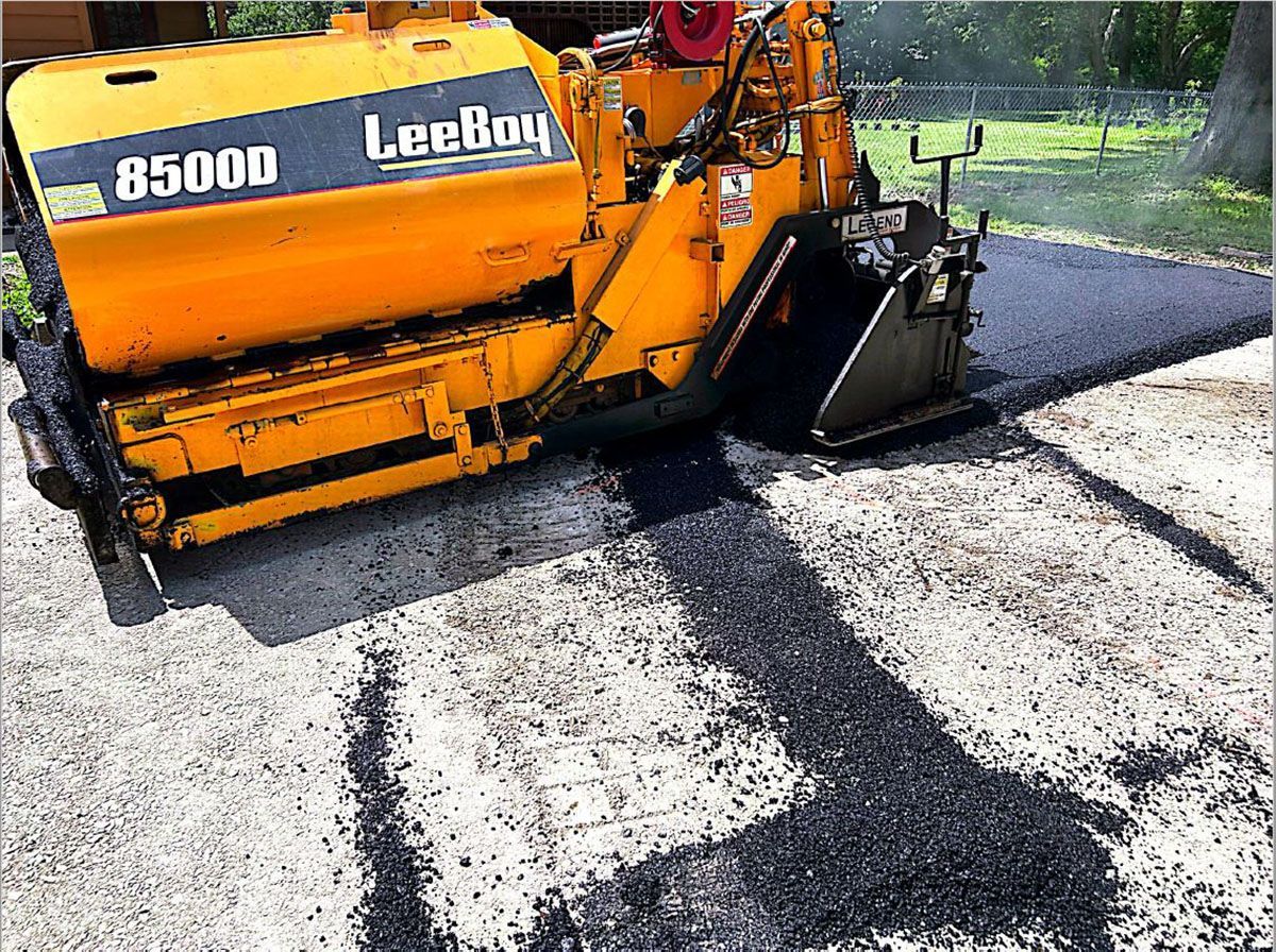 A heavy equipment laying asphalt on a road