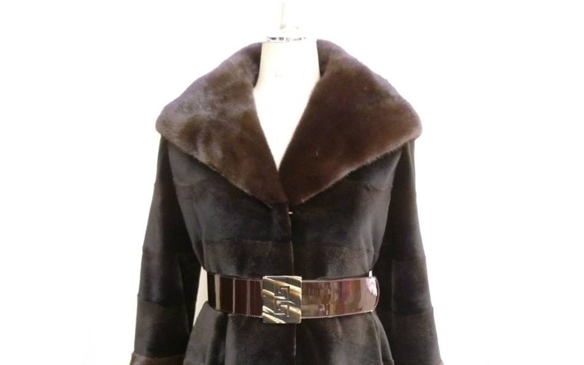 Dark brown fur coat with wide collar and belt, displayed on a mannequin.