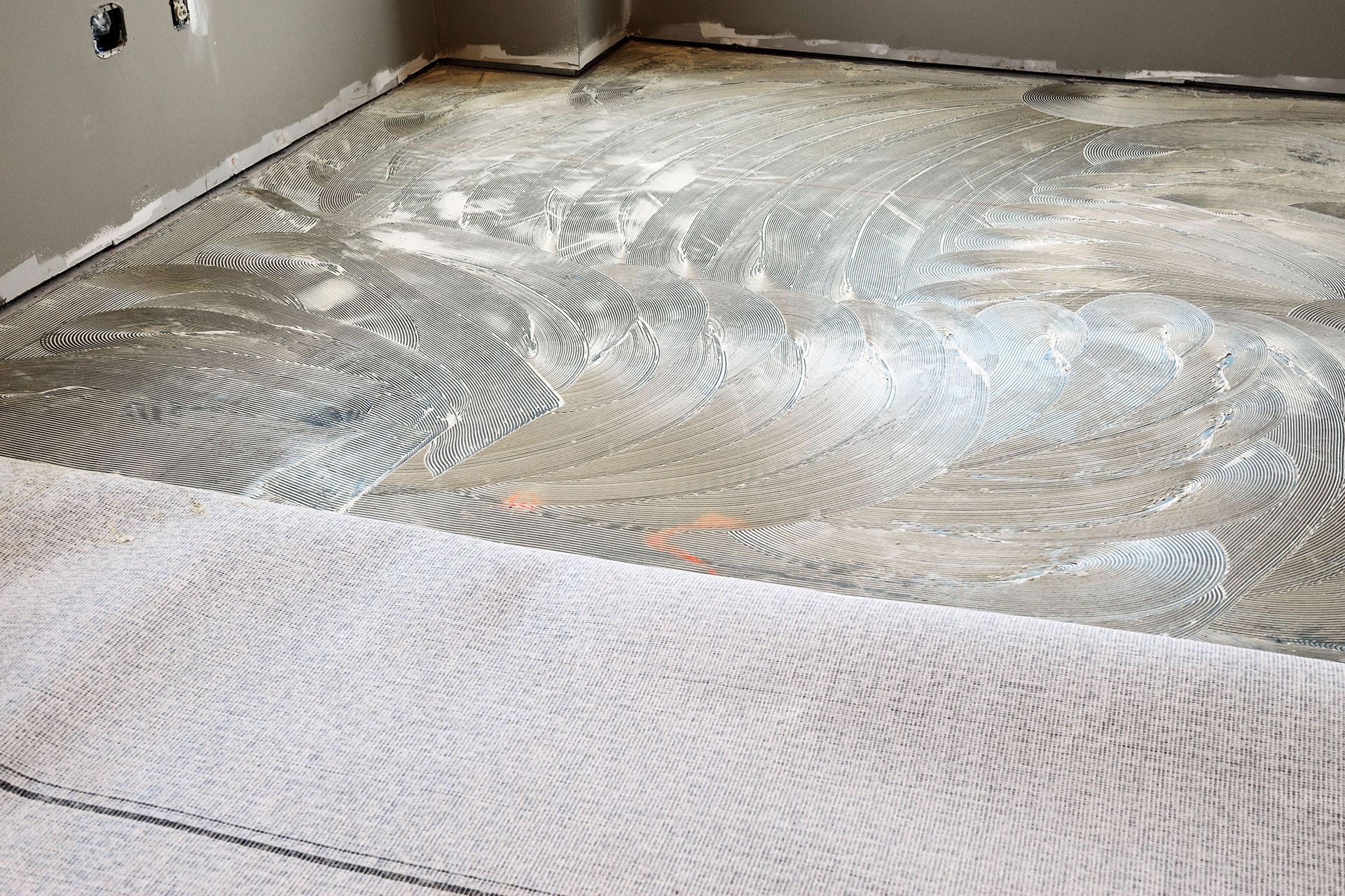 A tile floor is being installed in a room