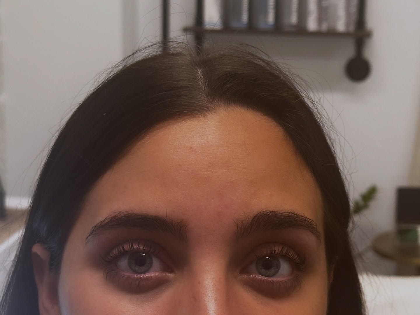 Woman with dark hair and brown eyes, looking directly at the camera.