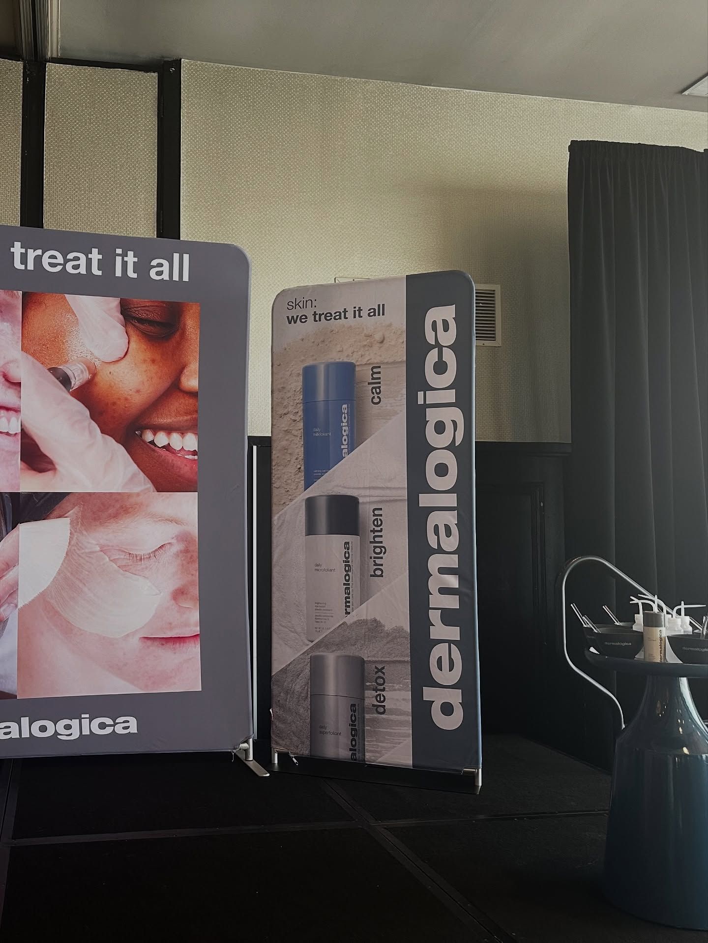 Dermalogica product display with packaging and promotional signage in a room.