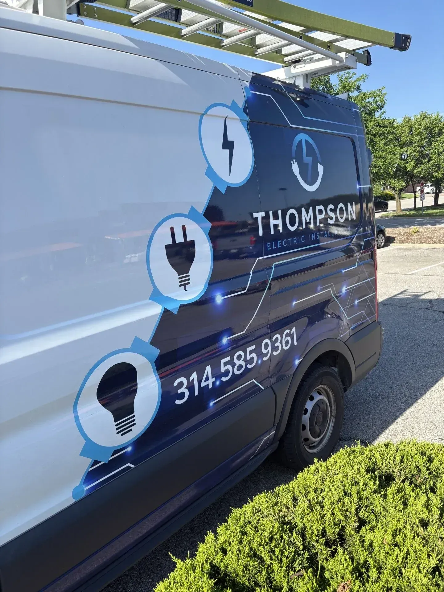 Thompson Electric van with logo, phone number, and ladder rack