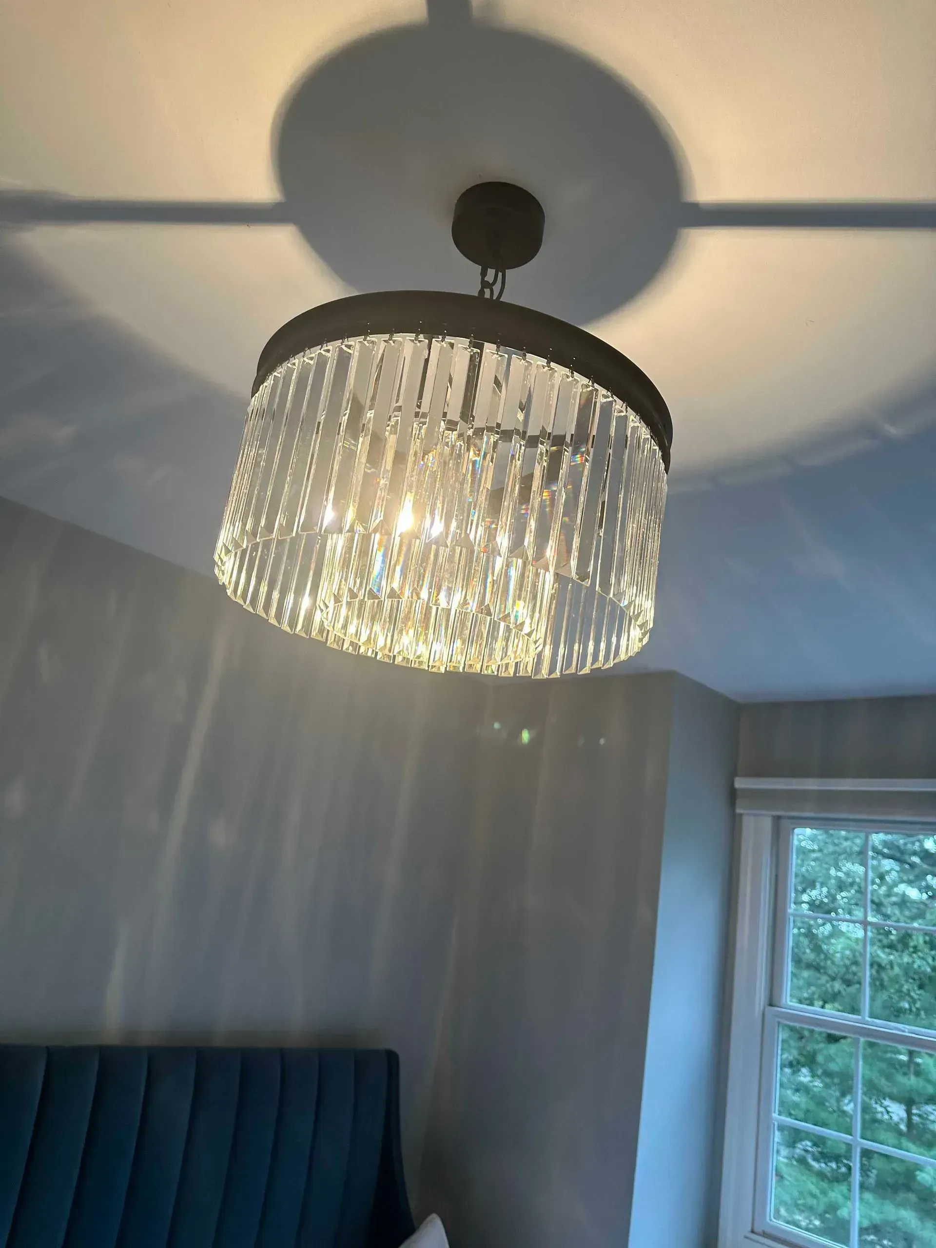 Crystal chandelier hanging from a white ceiling