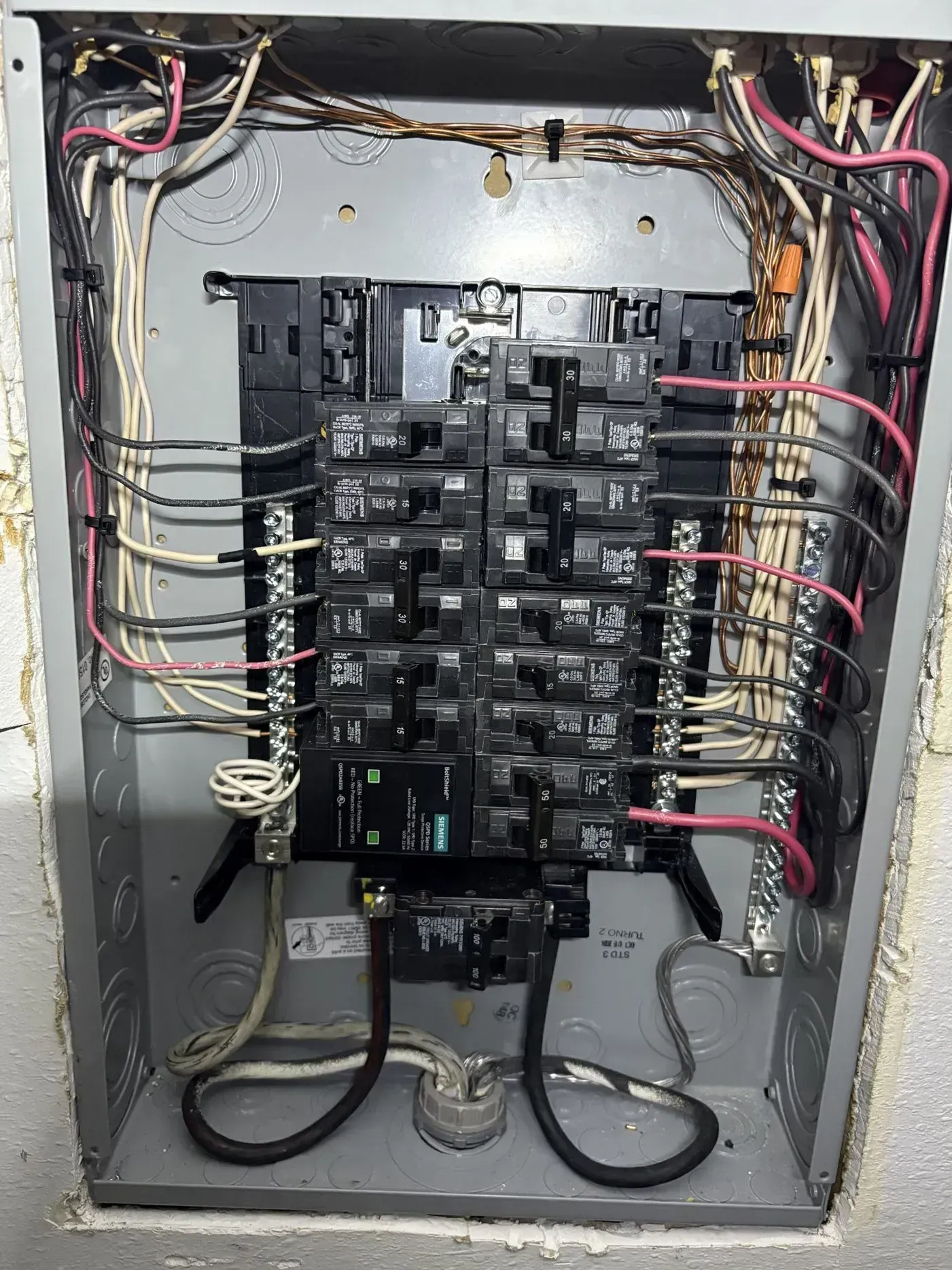 Electrical panel with numerous circuit breakers and wiring