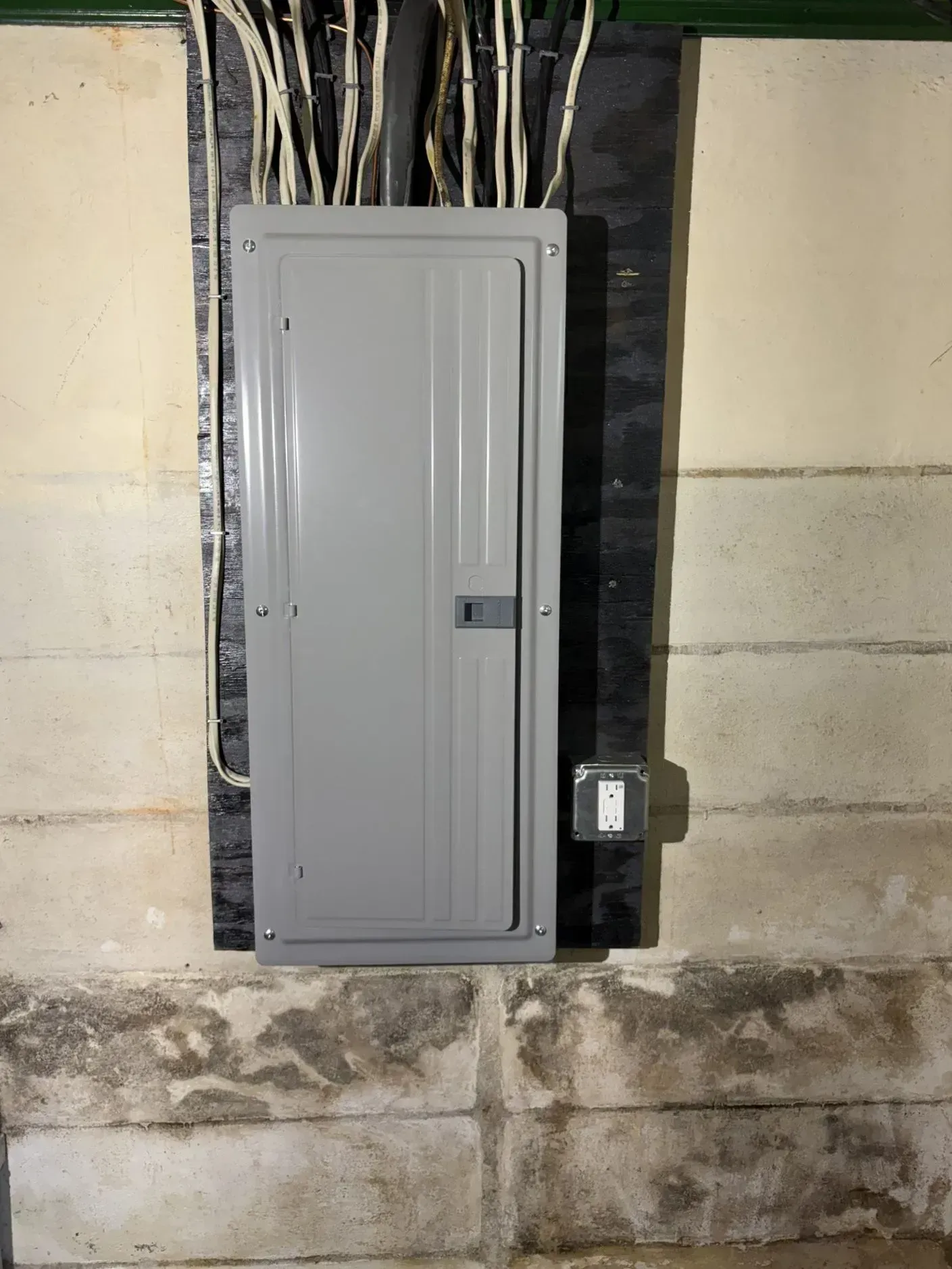 Gray electrical panel on a concrete wall