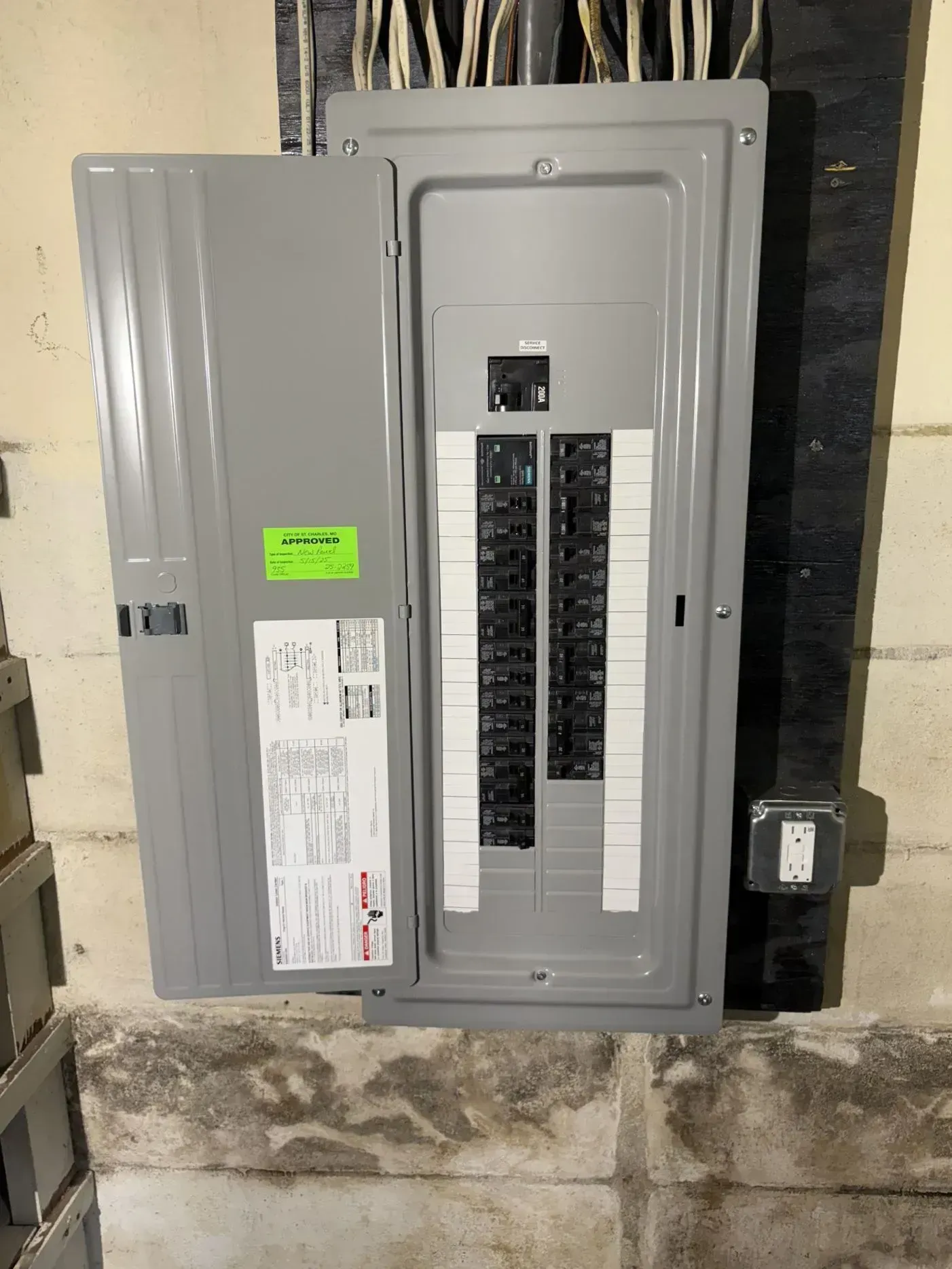 Electrical panel with the door open, revealing circuit breakers