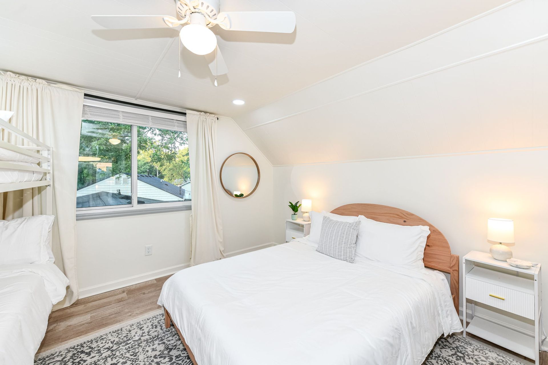 Hands pointing at paperwork with a pen, next to a miniature yellow house model.