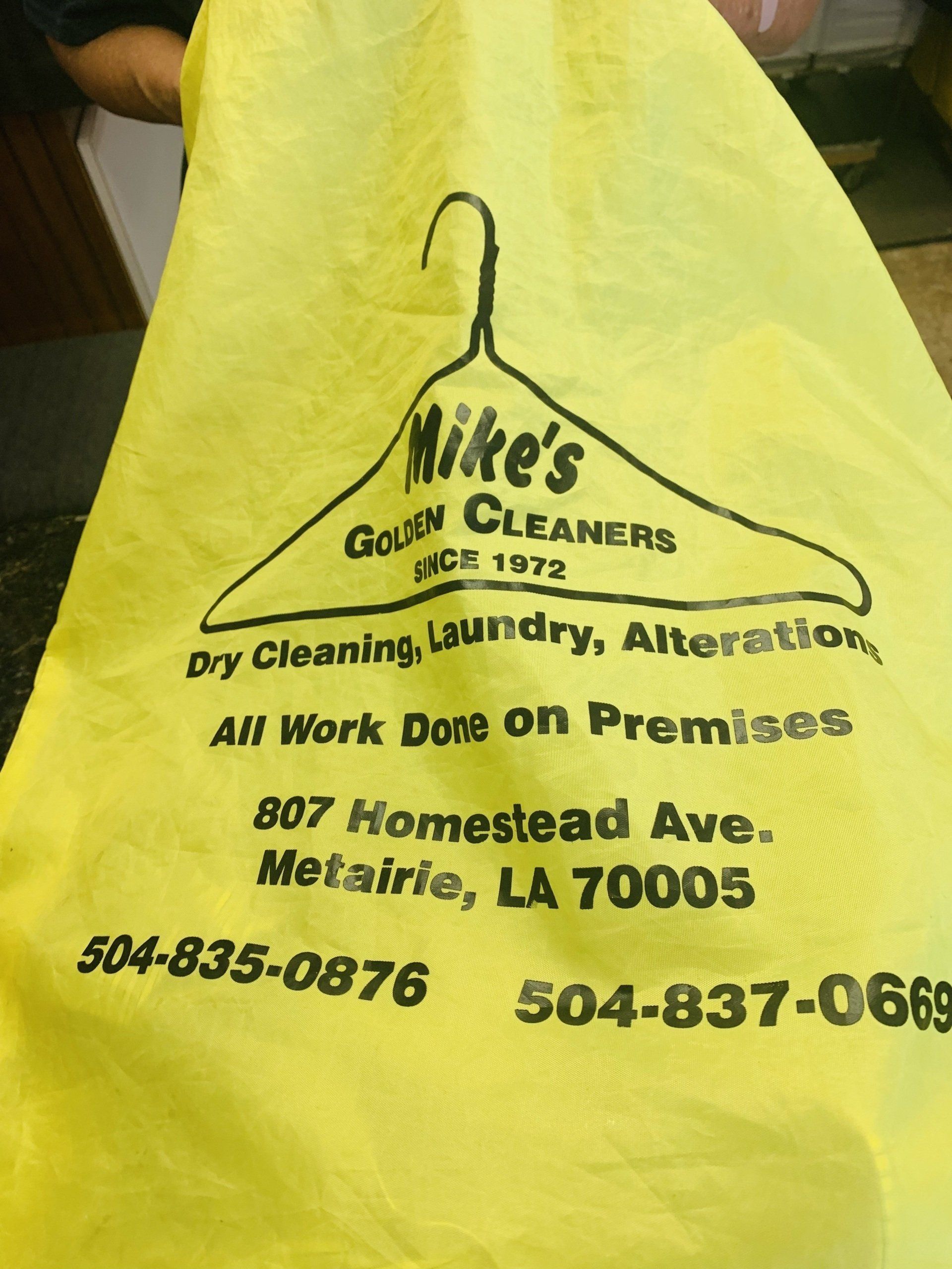Yellow shirt printed with Mike's Gold Cleaners logo, address, and phone numbers.
