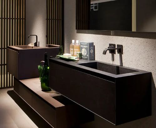 Modern black bathroom vanity with sink, mirror, wood slat wall, and green glass vase on a shelf