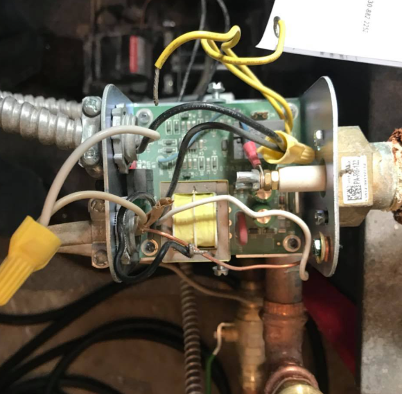 Close-up of exposed electrical wiring and components inside a metal device enclosure.