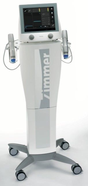 Medical imaging machine on a wheeled stand with a touchscreen and side handles, white and gray