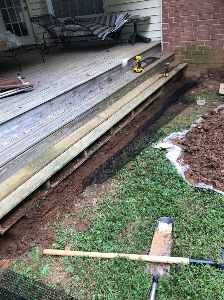 Dig barrier to prevent animals from going under deck