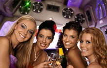 Group of women having party inside limousine