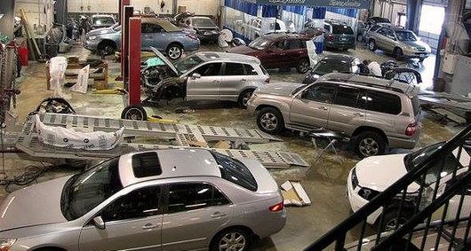 Cars inside auto repair shop