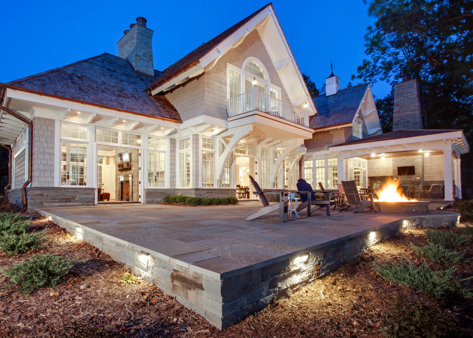 A large house with a porch and stairs in front of it.