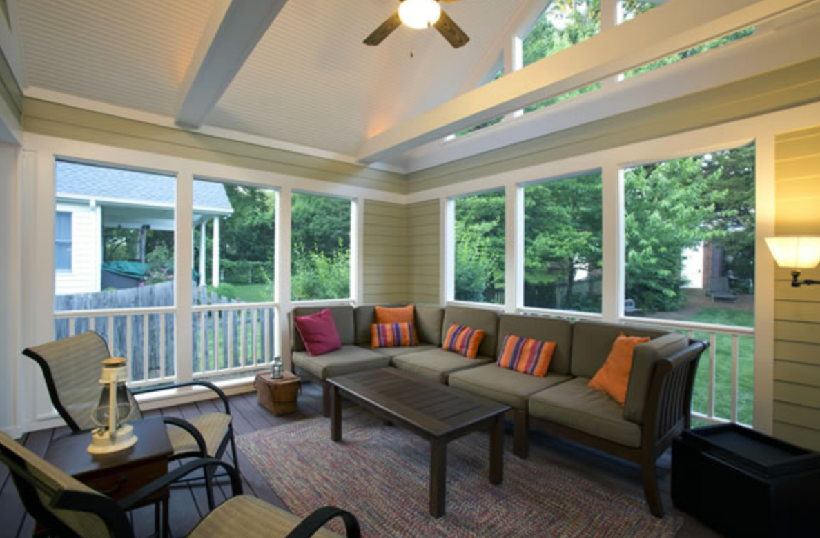 A large house with a white railing and stairs.
