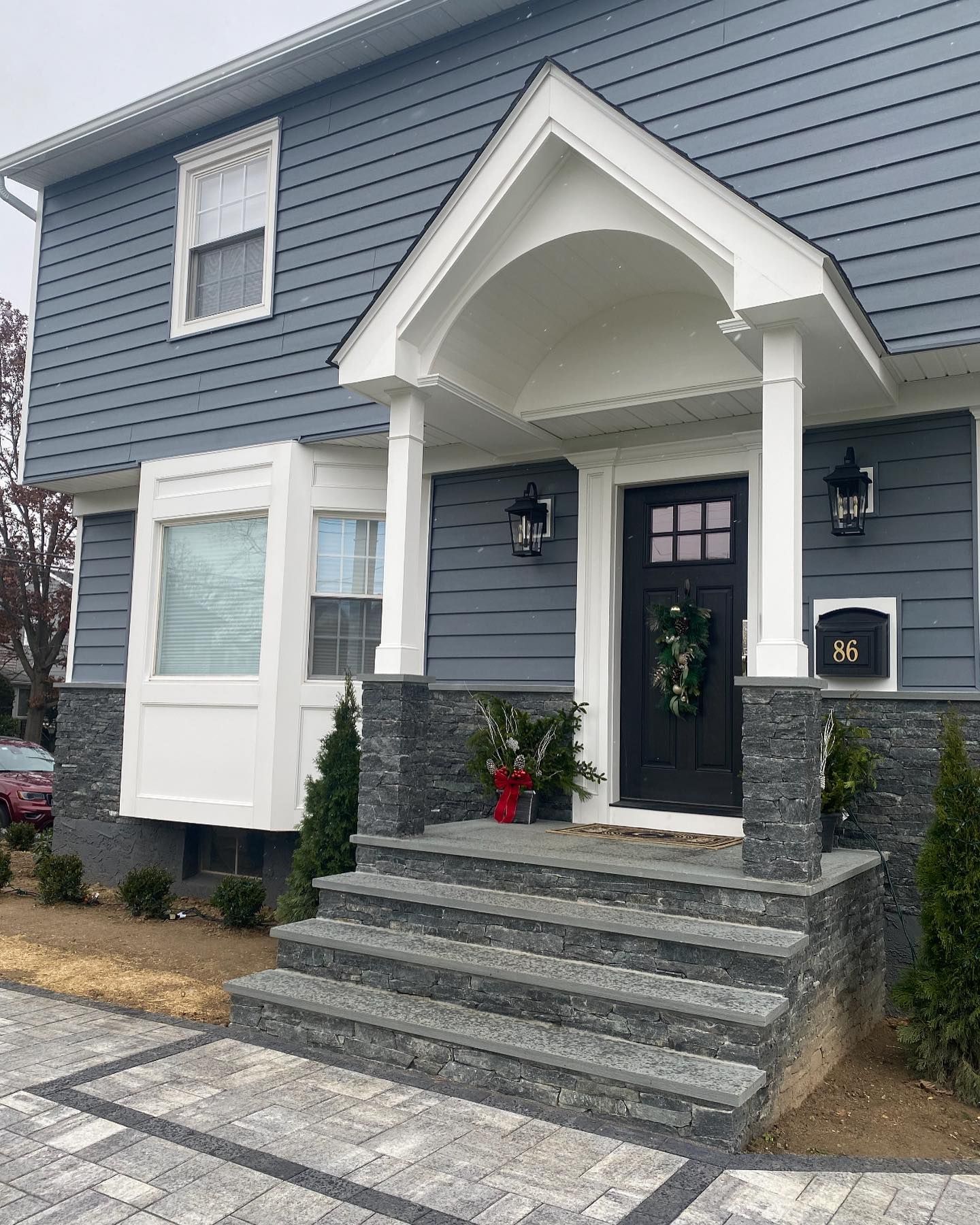 A blue house with a black door and steps