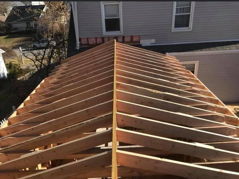 The roof of a house is being built with wooden beams