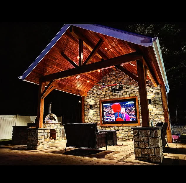 A gazebo with a large flat screen tv on the wall