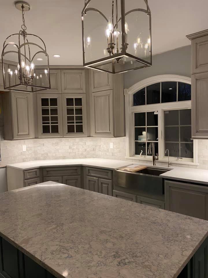 A kitchen with a large island and a sink.