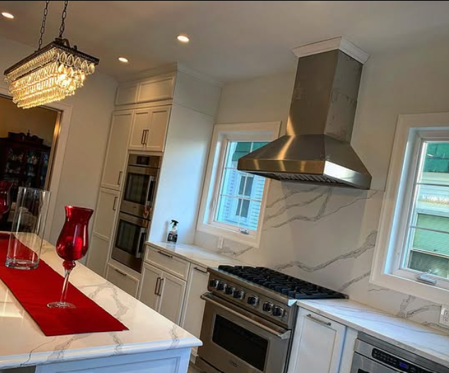 A kitchen with stainless steel appliances and white cabinets