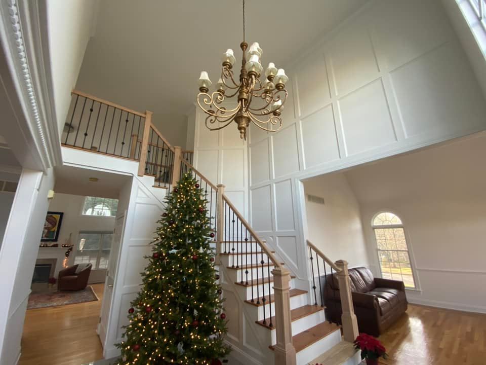 A living room with a staircase and a christmas tree