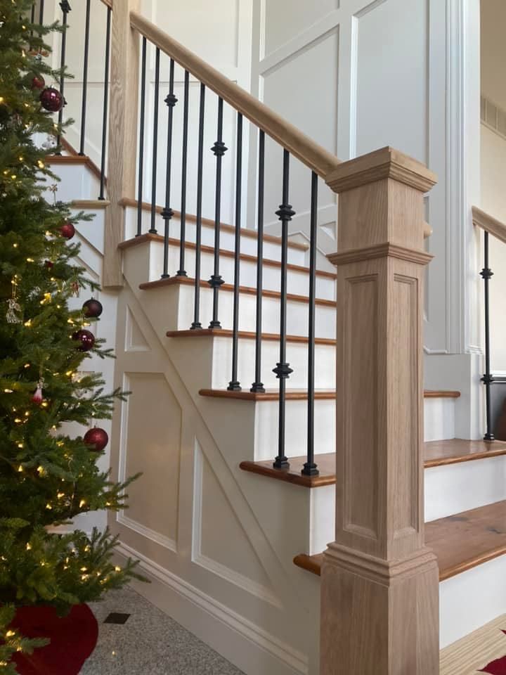 A staircase with a christmas tree in front of it