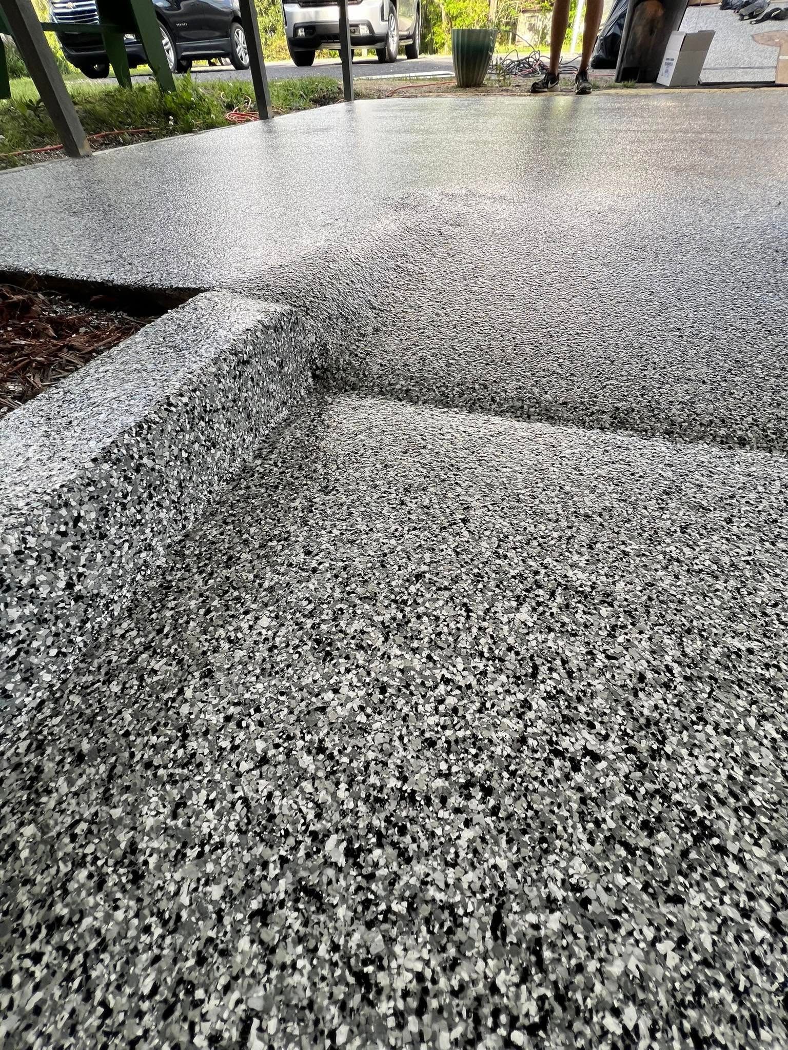 Gray speckled epoxy flooring; outdoor setting.