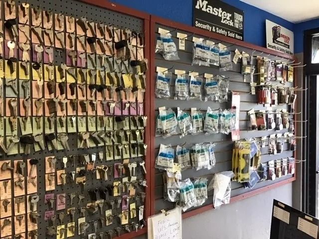 Key display with many keys and packaged lock parts in a store.