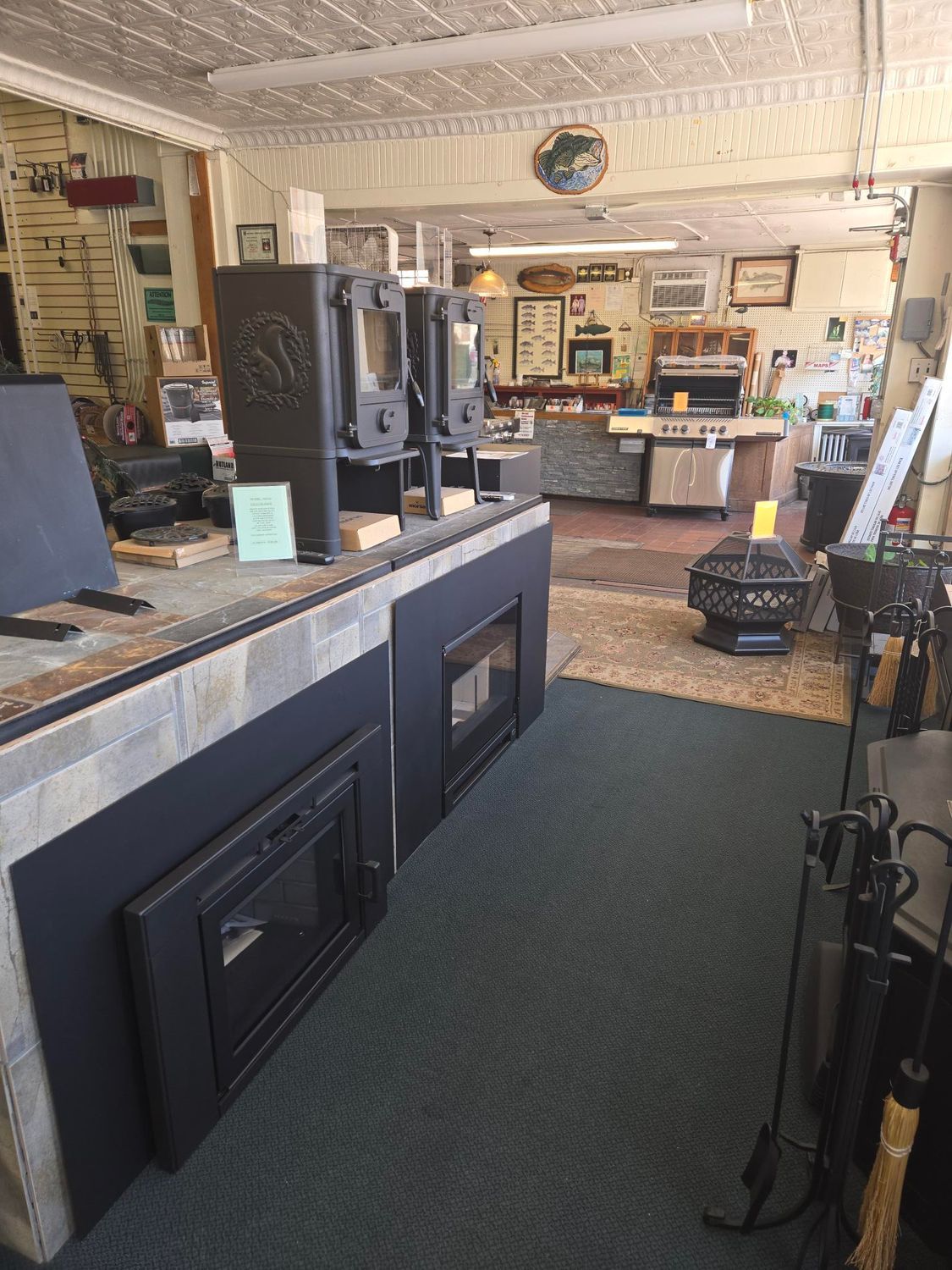 Interior of a rustic shop with shelves, counter displays, and a patterned floor rug