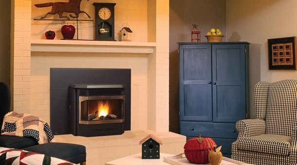 A living room with a fireplace and a wood stove.