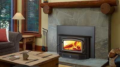 A living room with a fireplace and a wood stove.