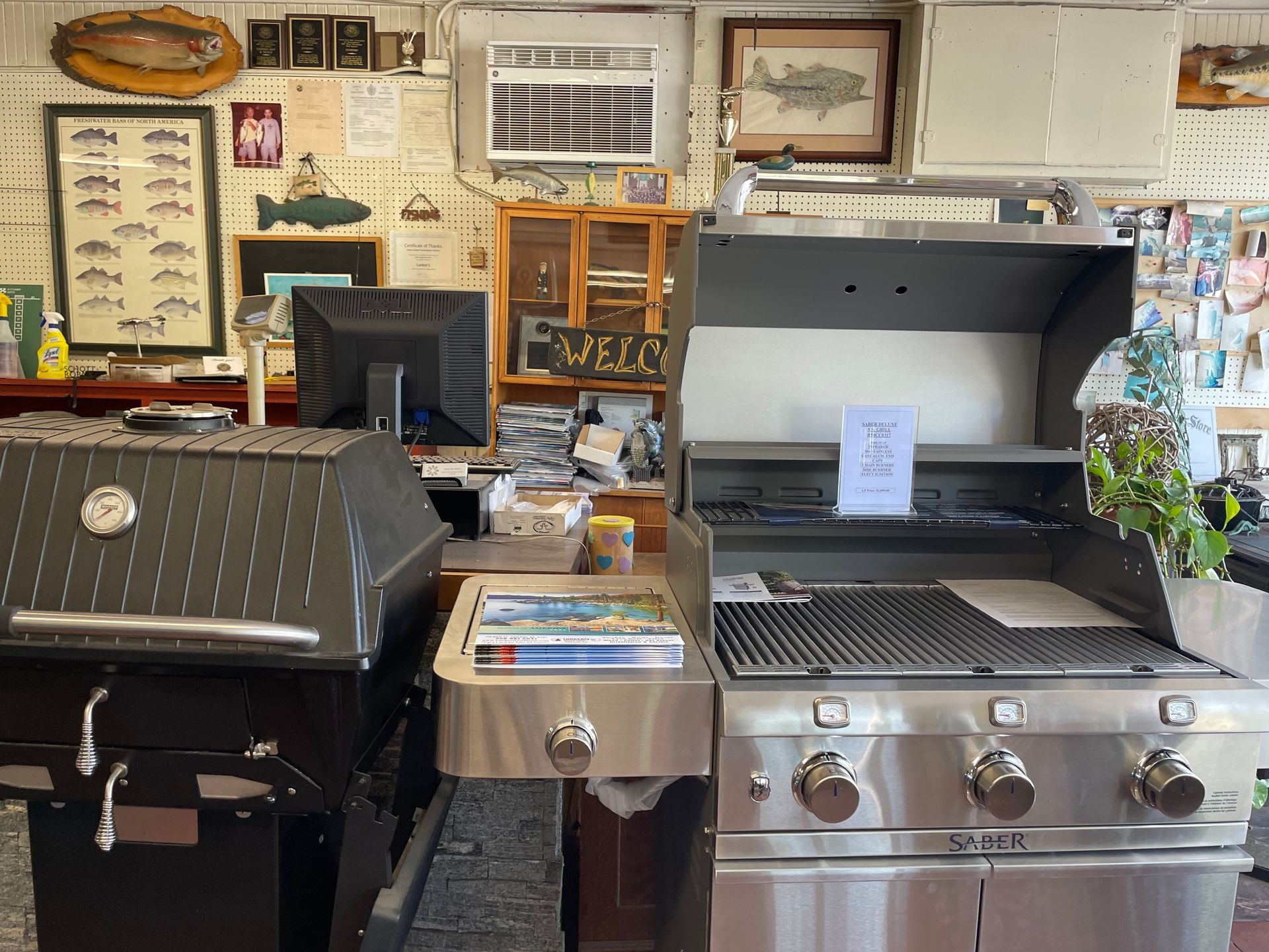 Two stainless steel grills are sitting next to each other in a room.