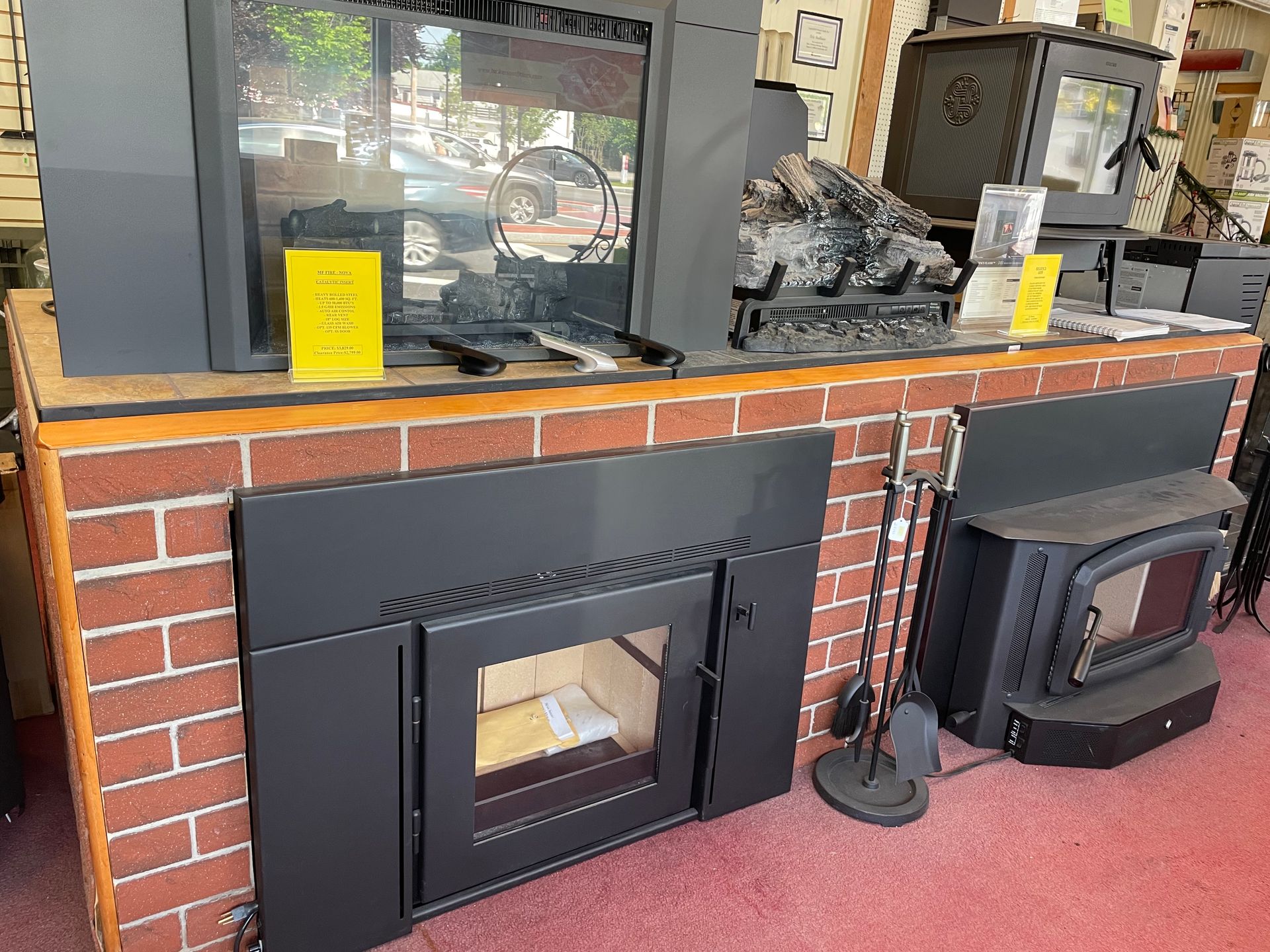 A fireplace is sitting on top of a brick counter in a store.