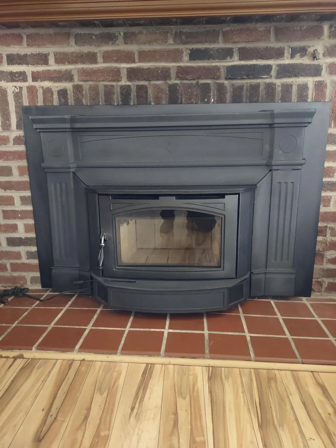 There is a fireplace with a wood stove in it.